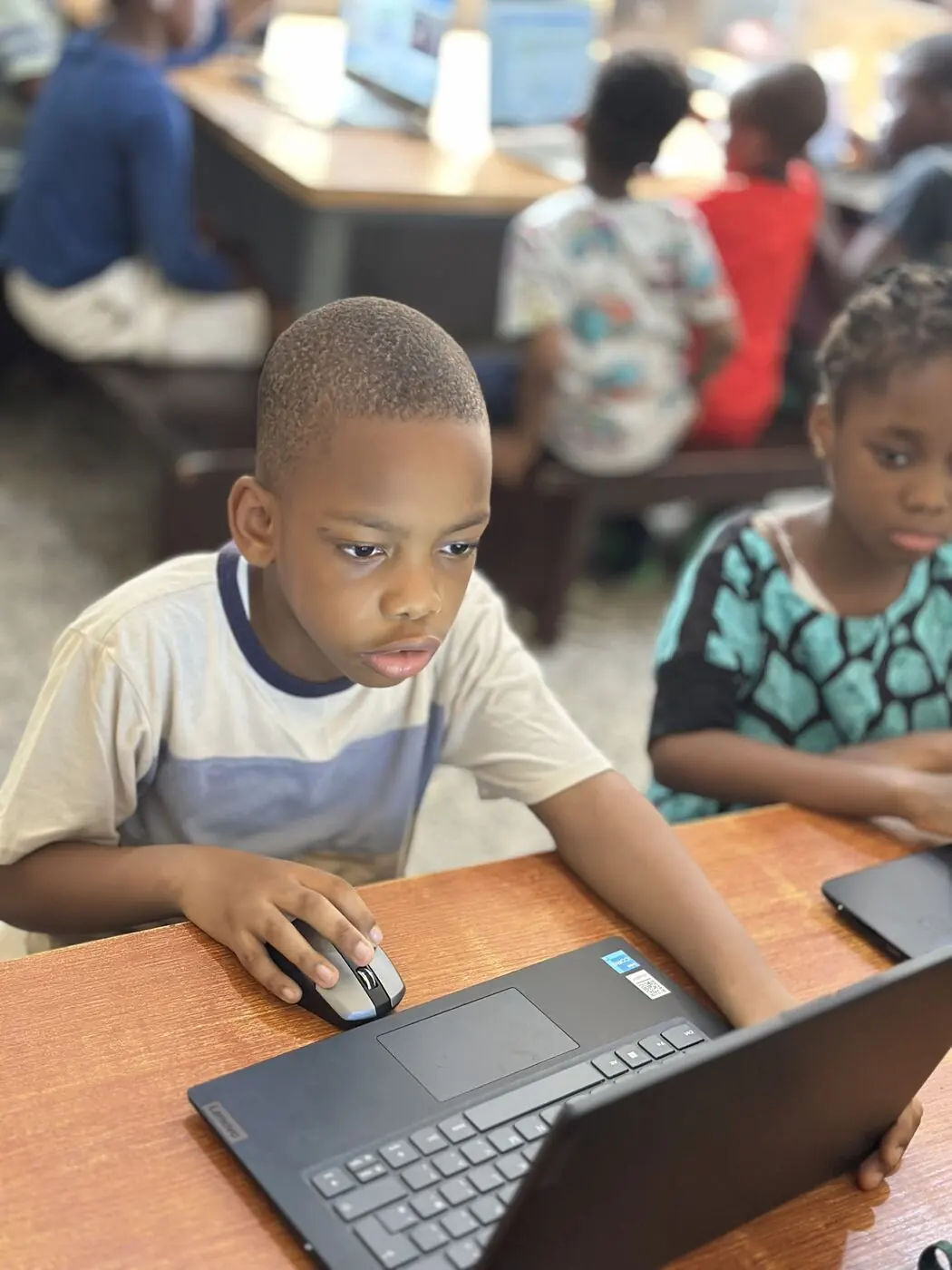 A Children's House child working independently on a Montessori material