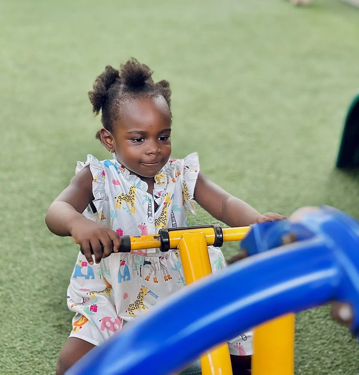 A toddler playing outdoors in the school garden
