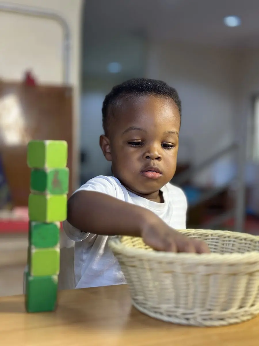 A toddler exploring materials in the Nido